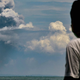 A man watches the Anak Krakatau volcano in Indonesia erupt on Saturday.